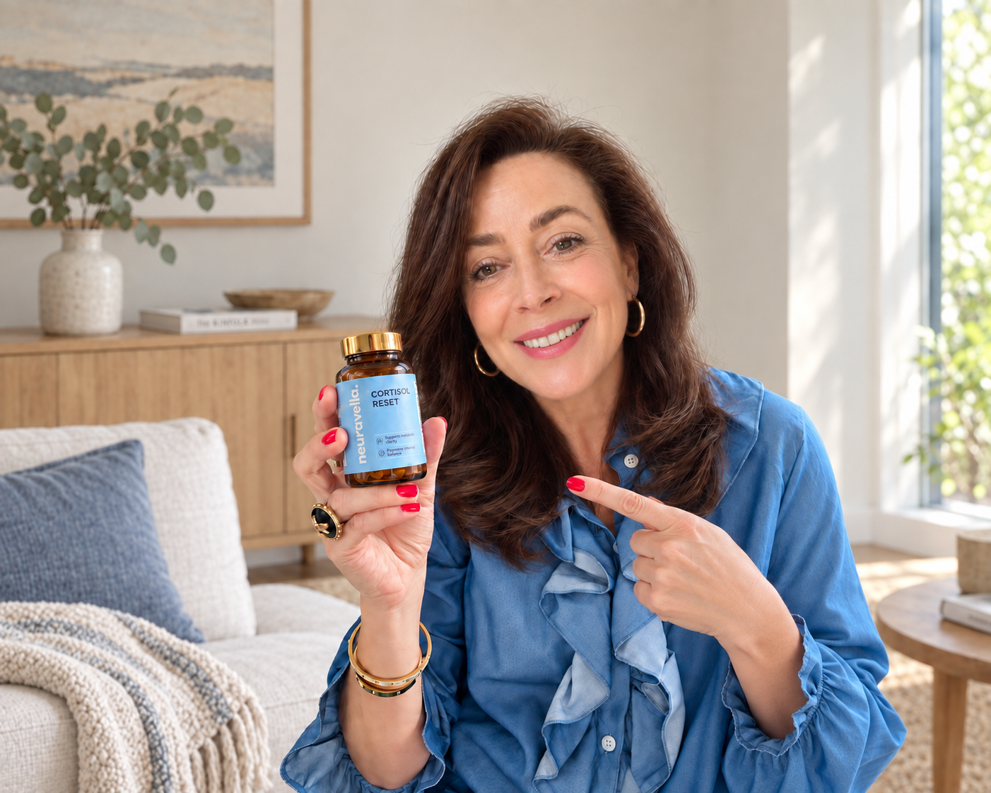 Smiling woman in a blue blouse pointing to Nature’s Cortisol Reset